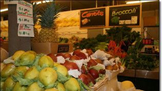 A display of fruits and vegetables including broccoli and cantaloupe