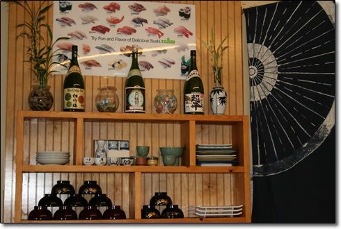 A wooden shelf with bottles and vases on it