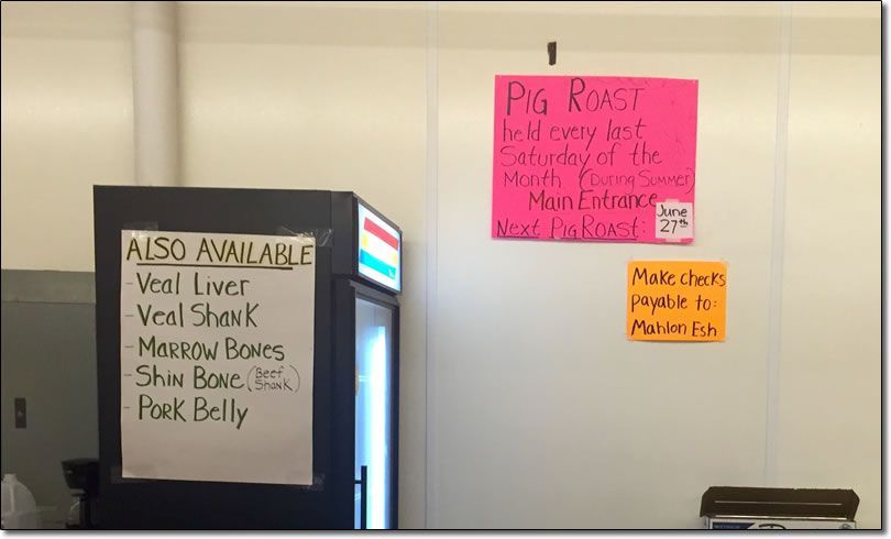 A sign on a wall that says pig roast