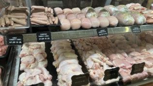 A display case filled with a variety of meats and eggs.