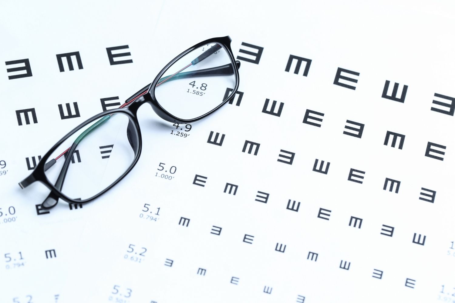 Eye exam with doctor and patient at a slit lamp in a bright clinic
