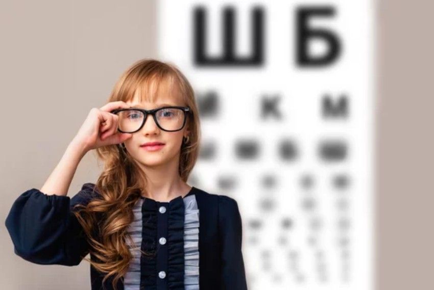 Eye exam with doctor and patient at a slit lamp in a bright clinic