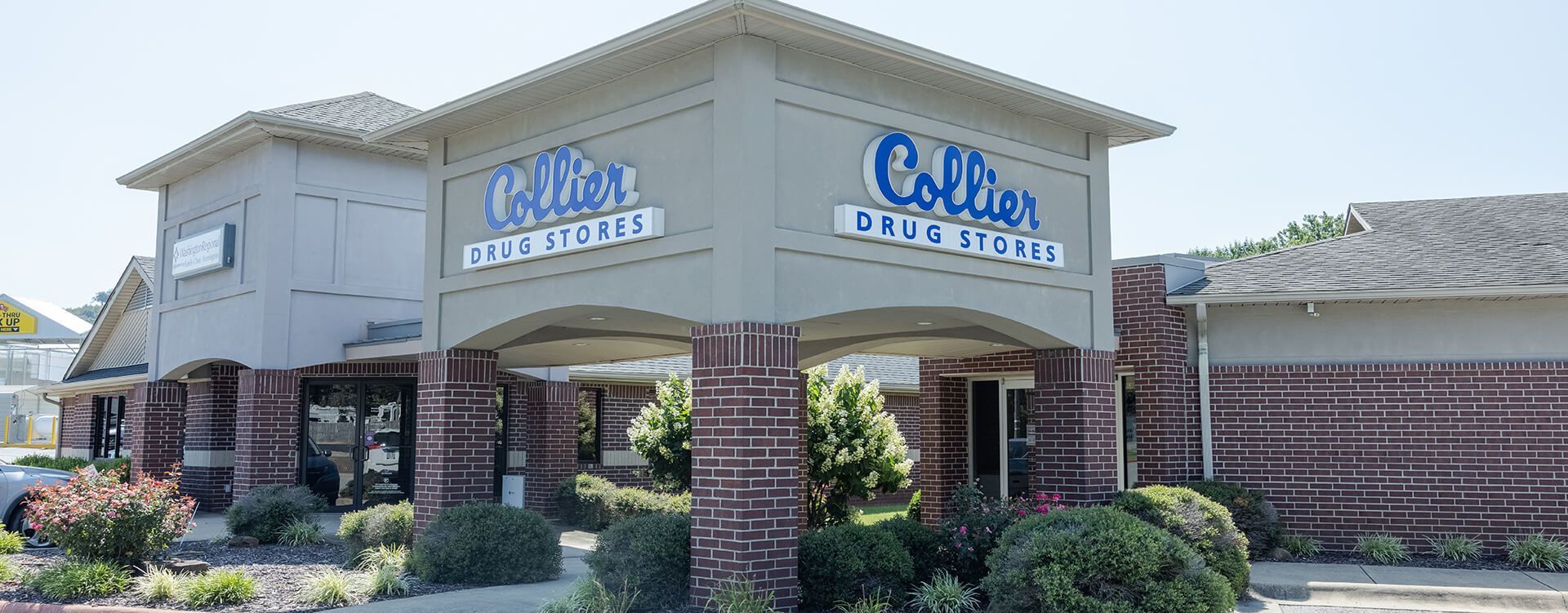 A brick building with a blue sign on the side of it.