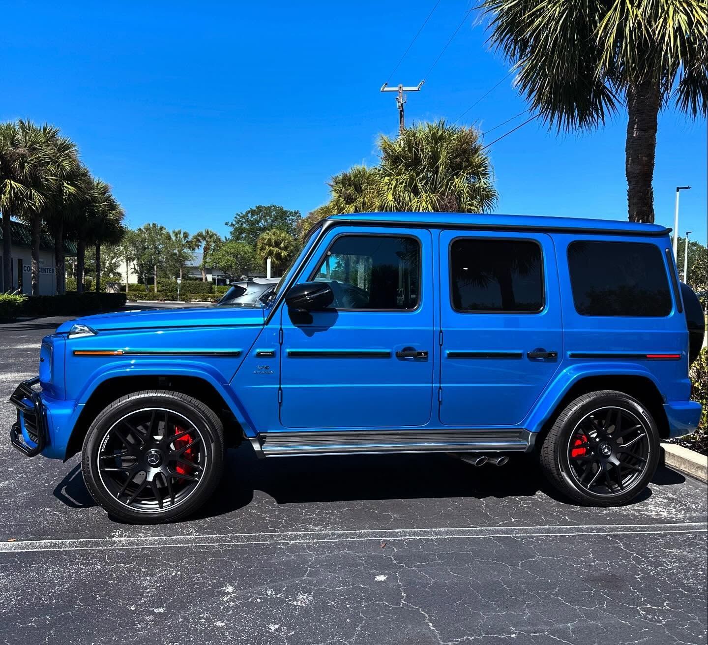 Bright blue Mercedes-Benz SUV with dark rear windows and black wheels, shown in profile.