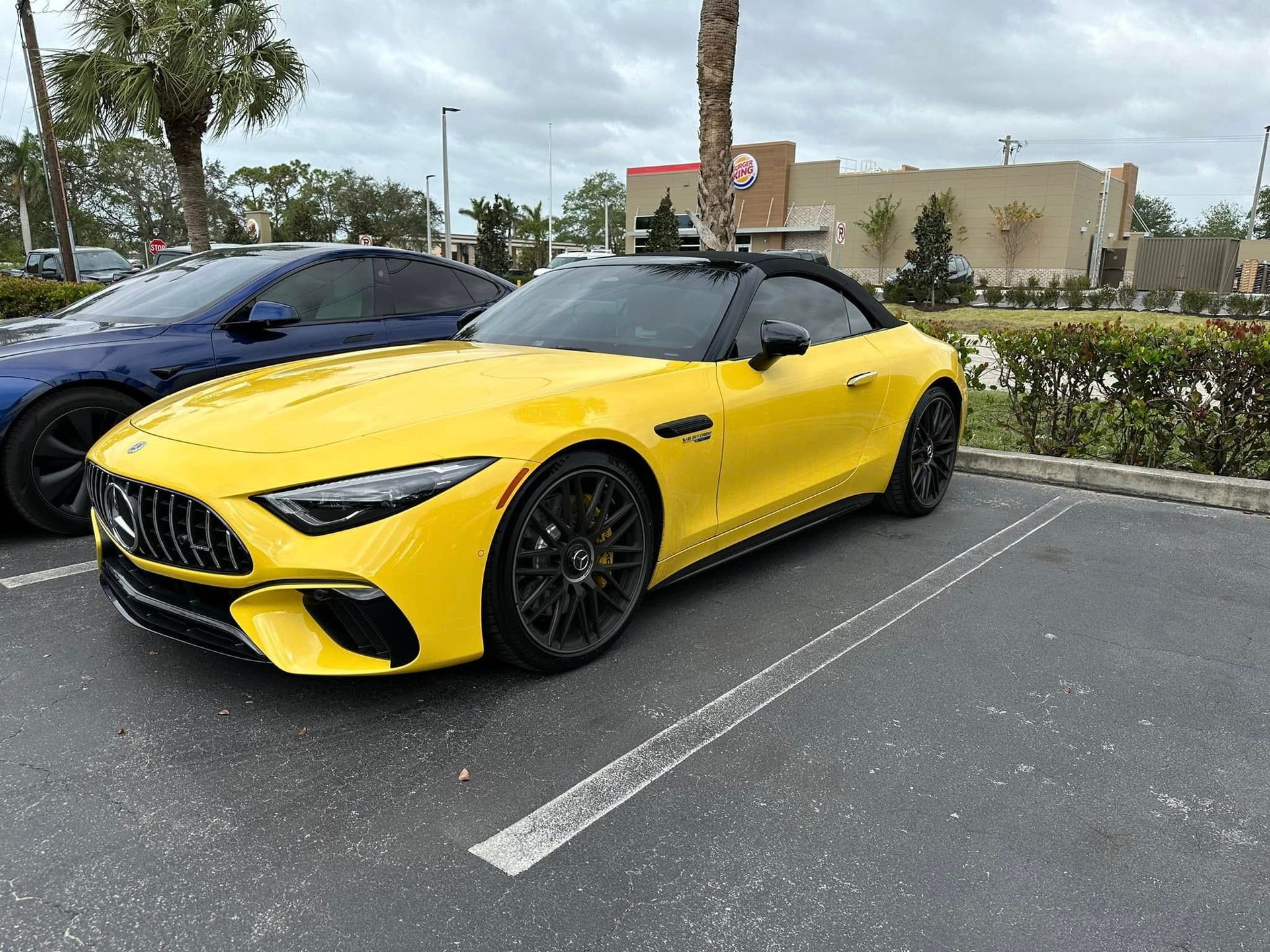 Yellow Mercedes-Benz convertible parked outside