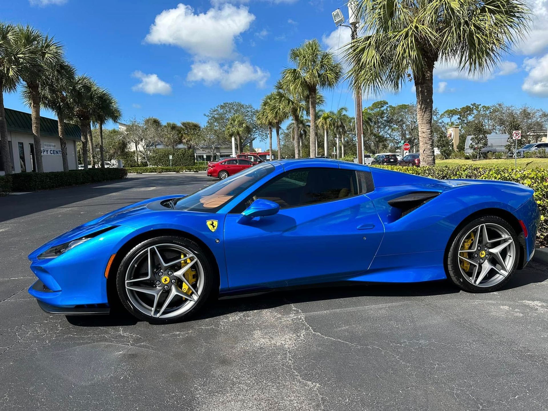 Blue Ferrari sports car with tinted side windows