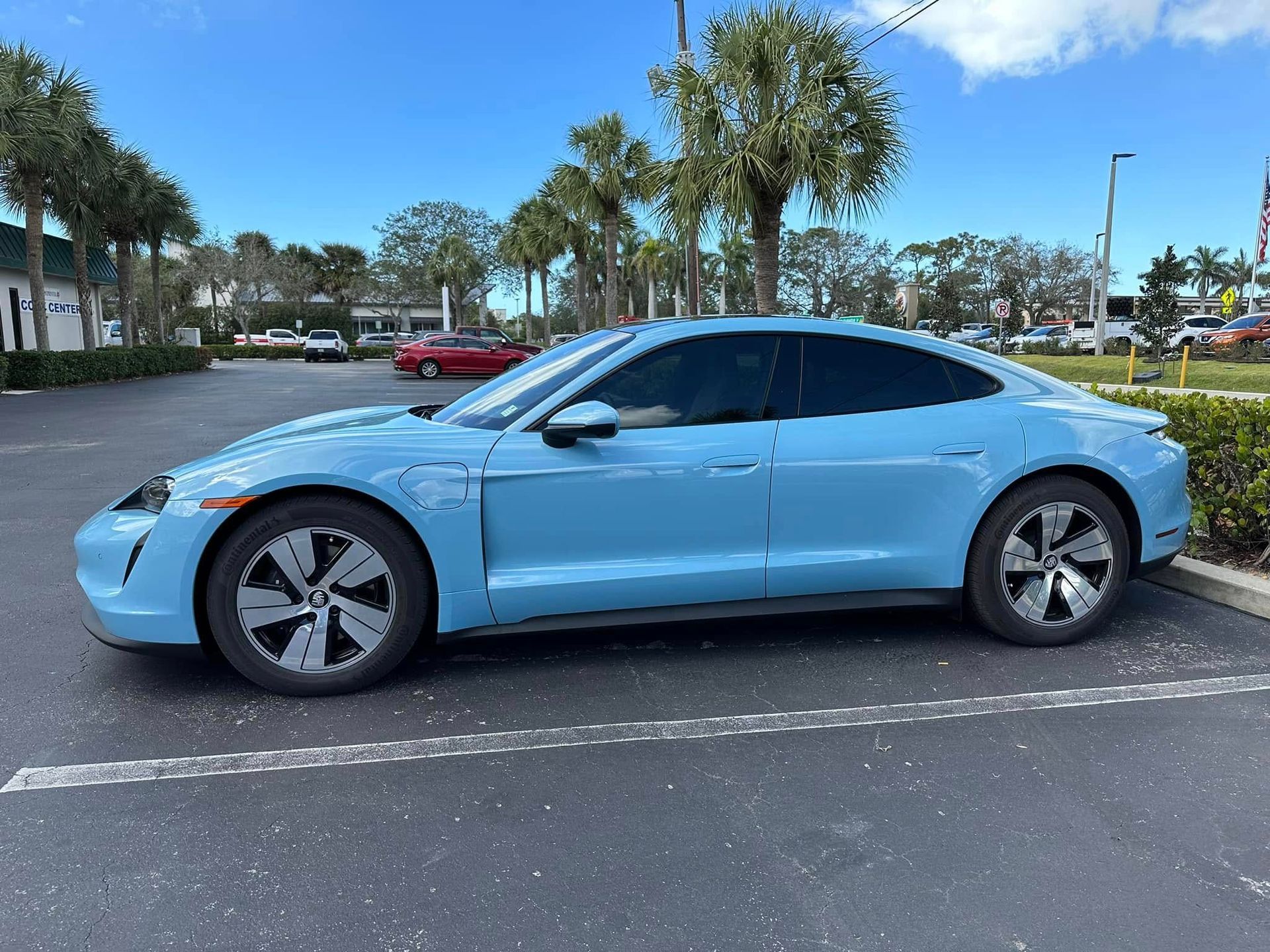Light blue Porsche sedan with dark side windows, shown in profile.