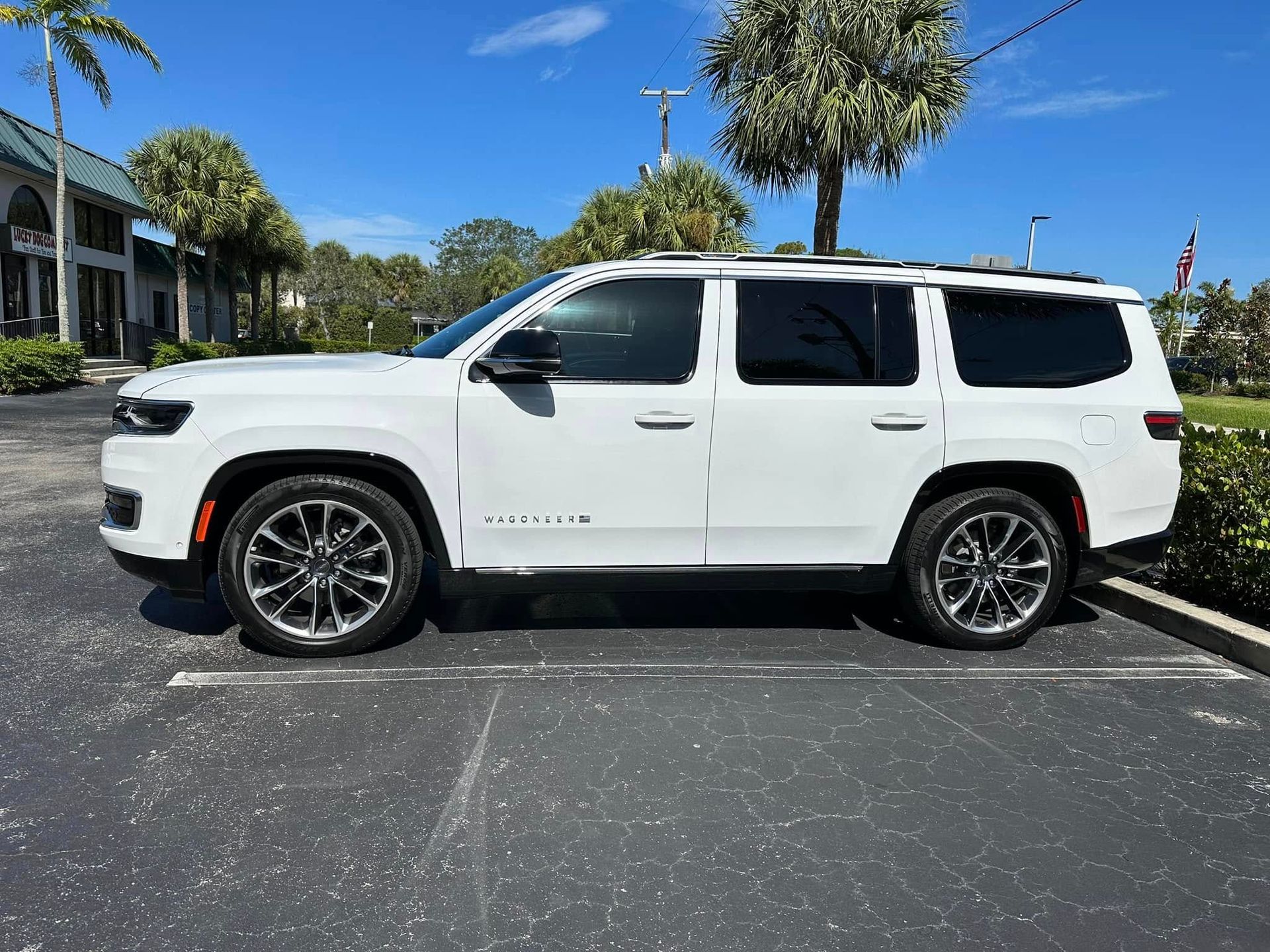 White Chevrolet SUV with dark rear windows, shown in profile.