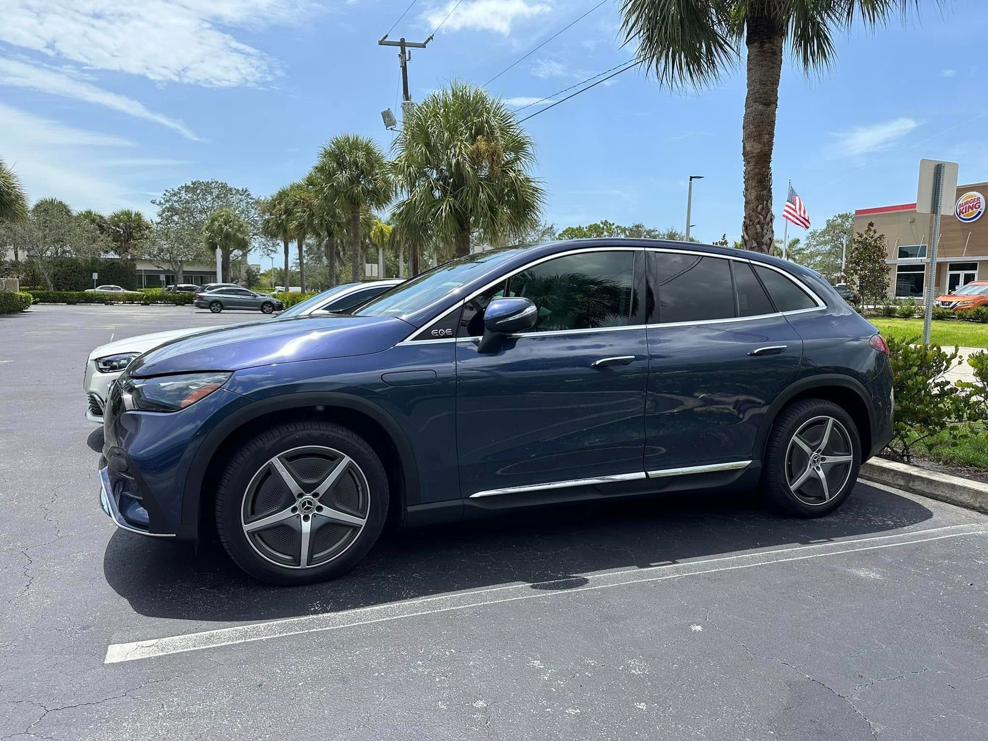 Dark blue Mercedes-Benz SUV with dark rear windows, viewed from the front and side.