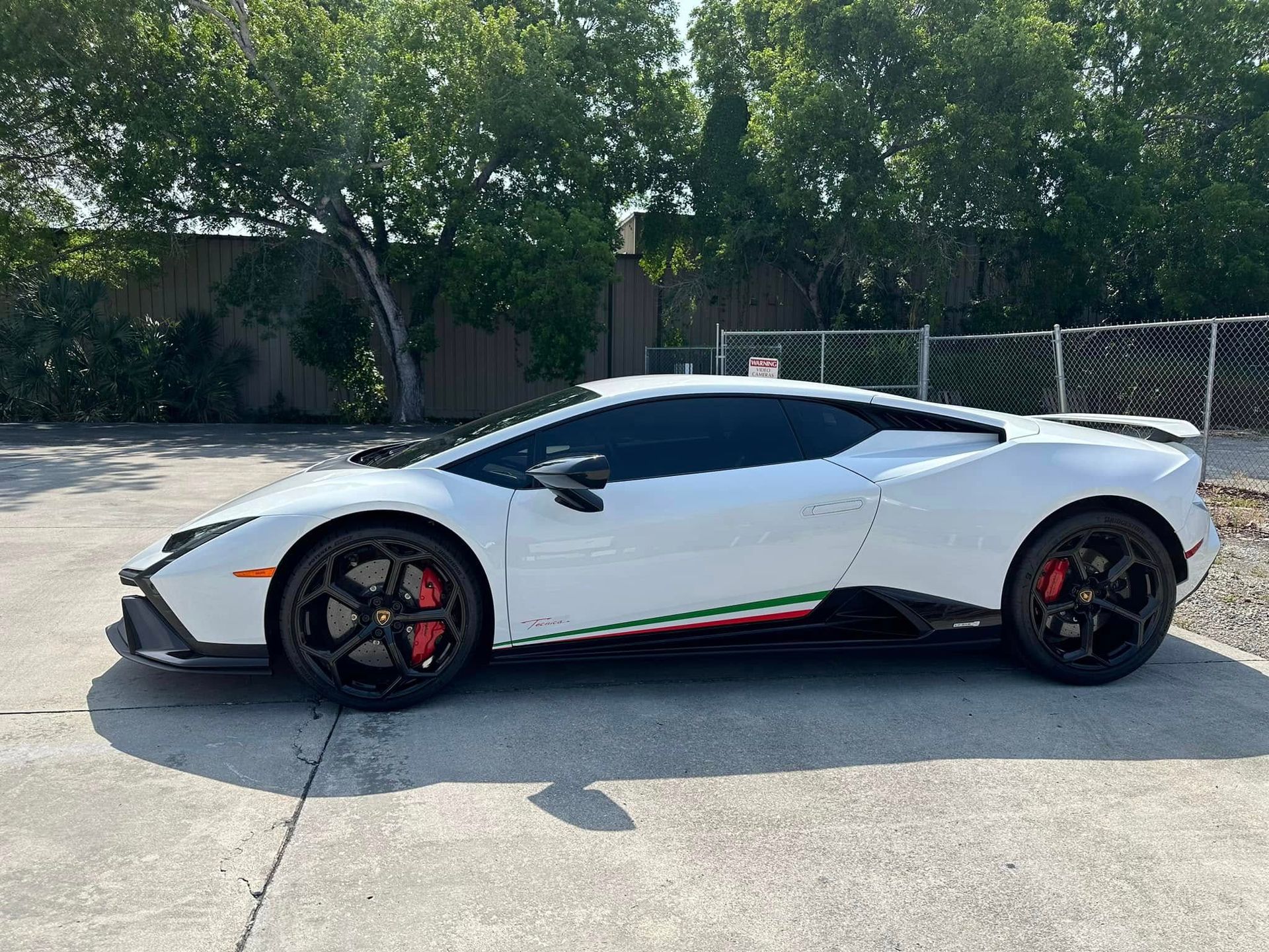 White Lamborghini coupe with tinted side windows
