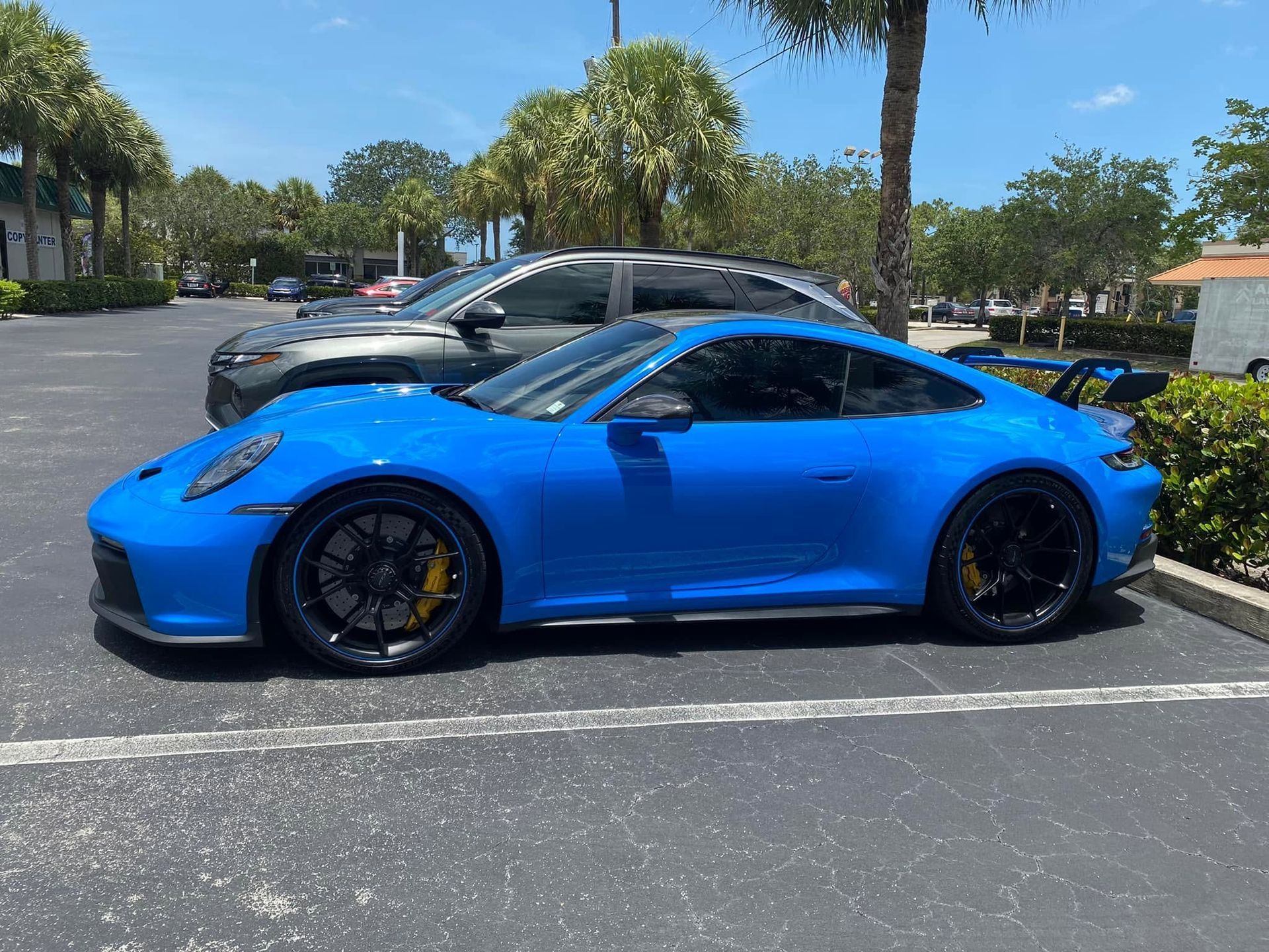 Blue Porsche coupe with tinted windows