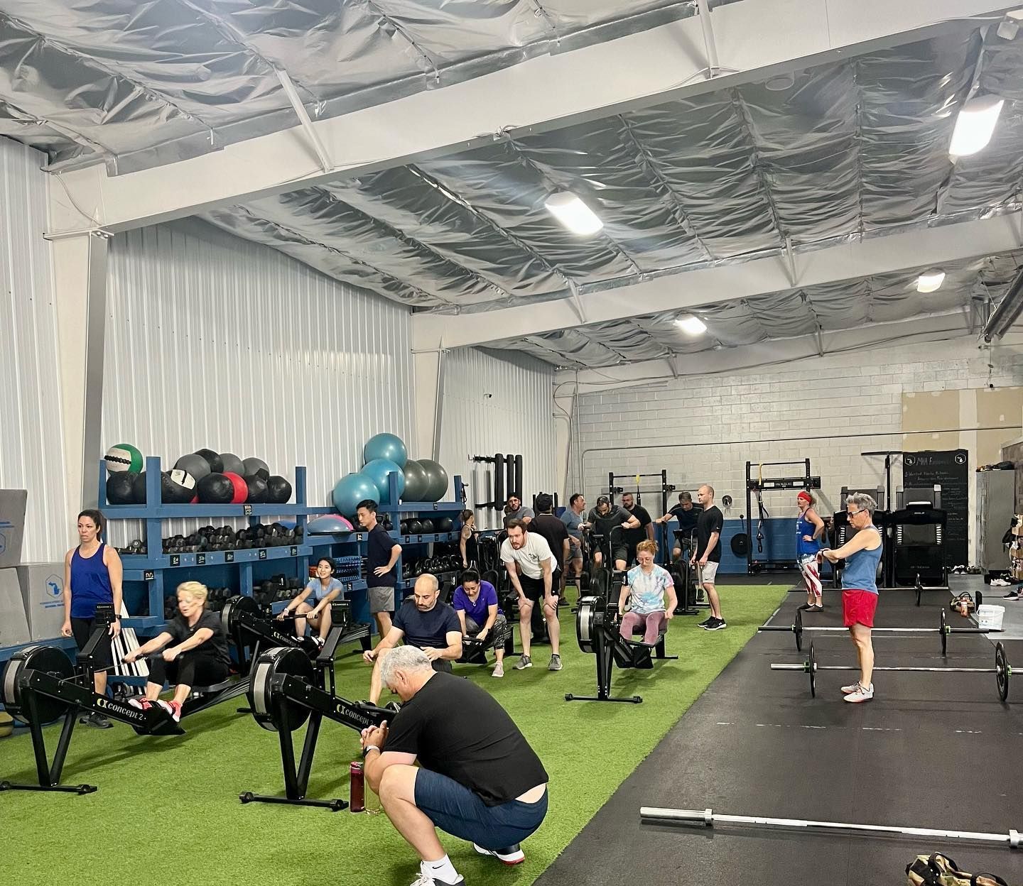 A group of people are doing exercises in a gym.