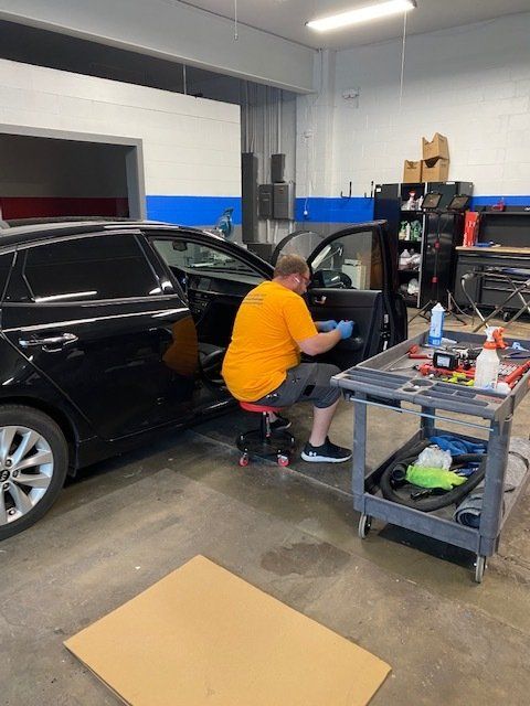 Woman Replacing The Windshield Of A Car — Belleville, IL — Glass & More Inc.