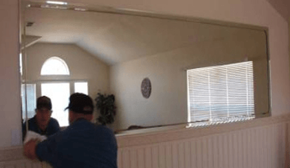 Worker Installing A Mirror Glass — Belleville, IL — Glass & More Inc. Worker Installing A Mirror Glass — Belleville, IL — Glass & More Inc.