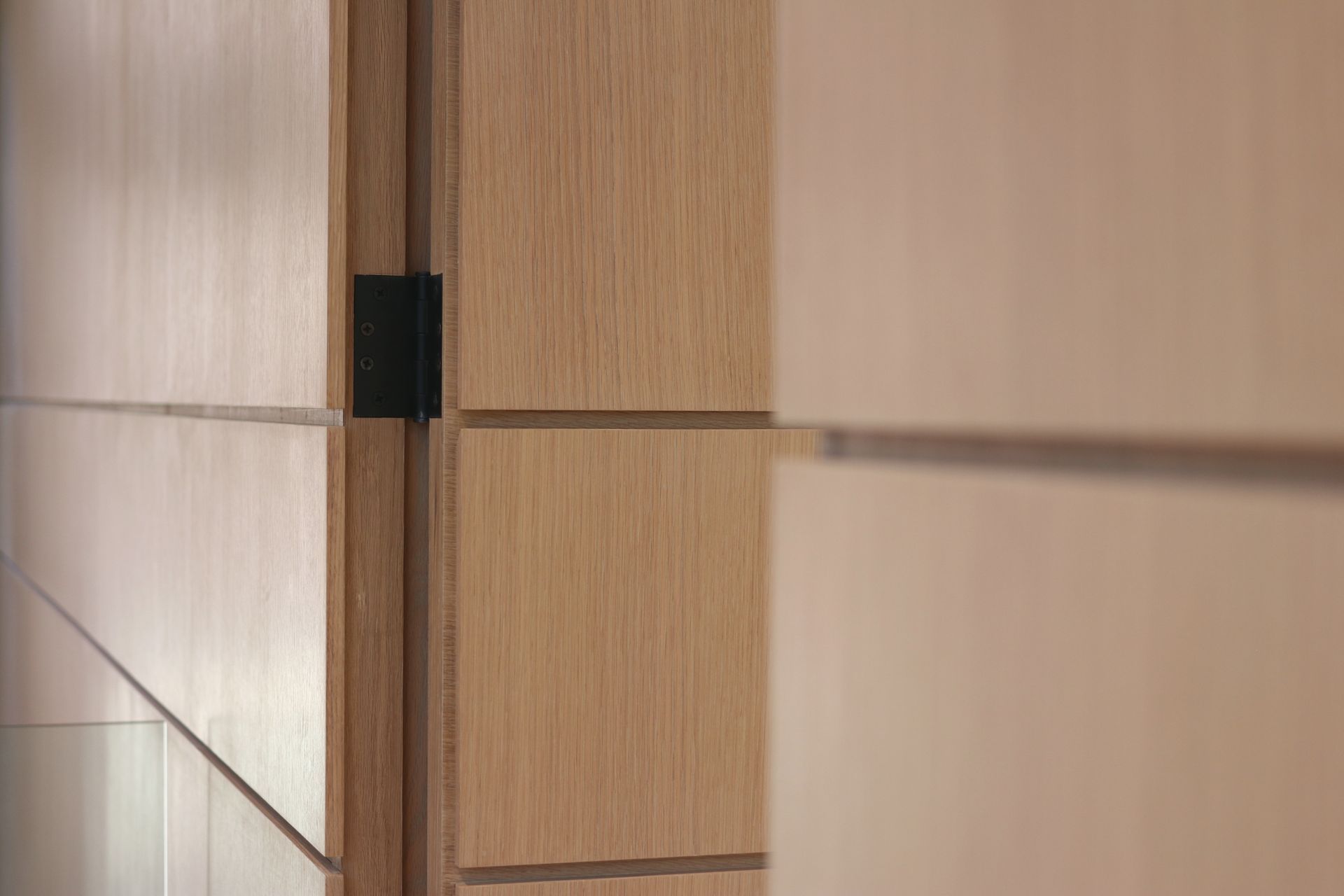 a close up of a wooden wall with a door in the background .