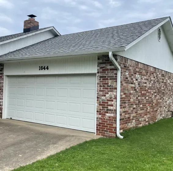 A white garage door with the number 1844 on it