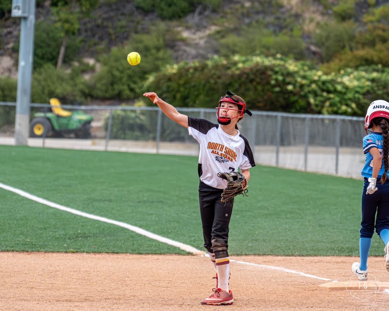 Baseball on a dark surface, with visible stitching.