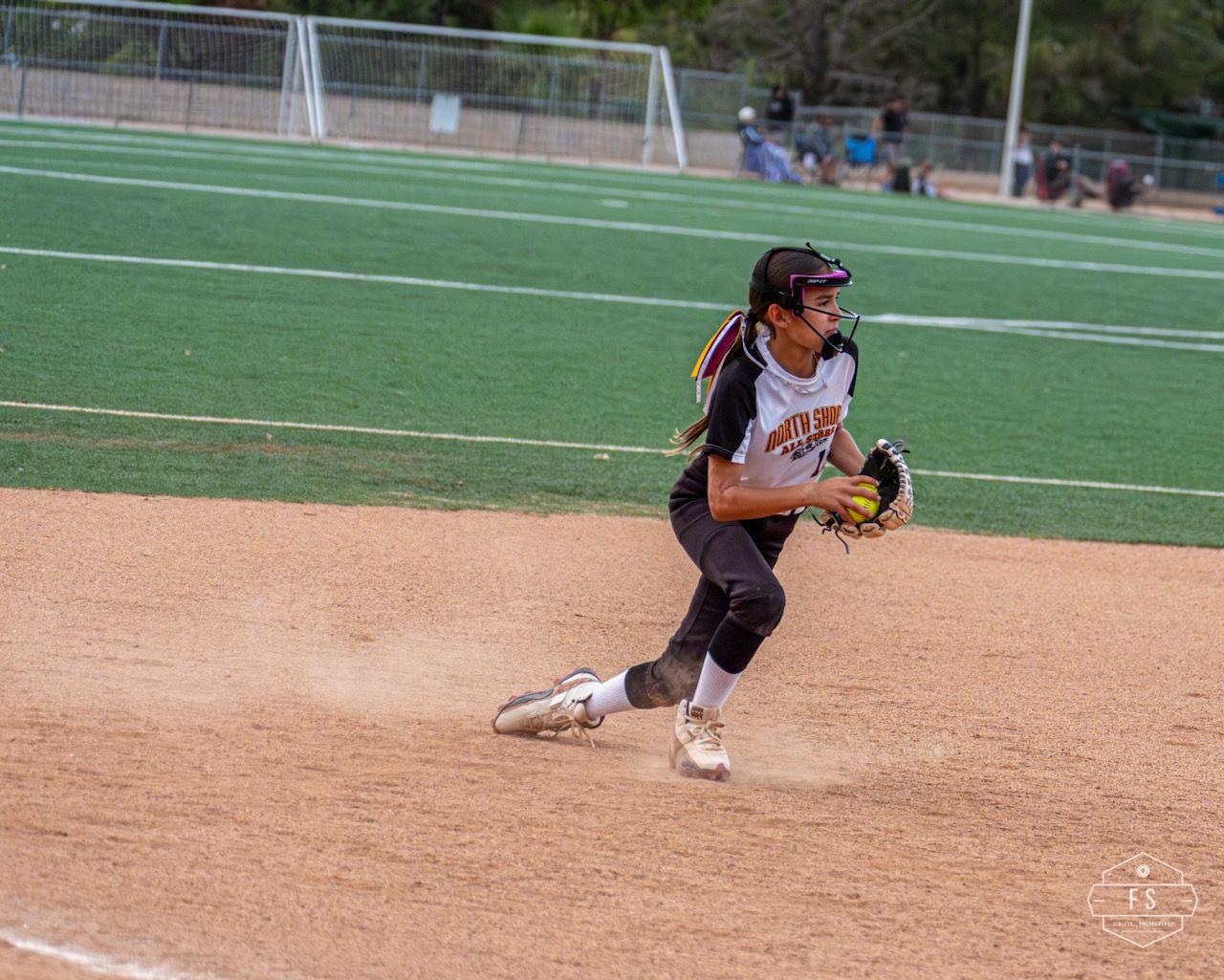 Softball player fielding the ball