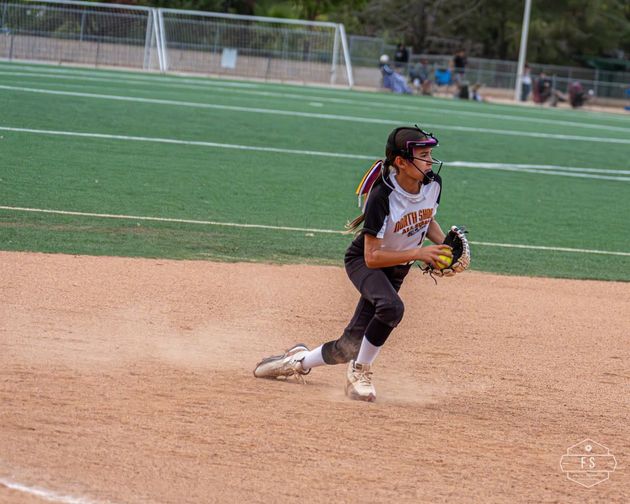 Softball player fielding the ball