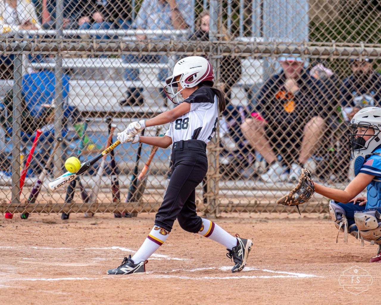 Softball player making contact with the ball
