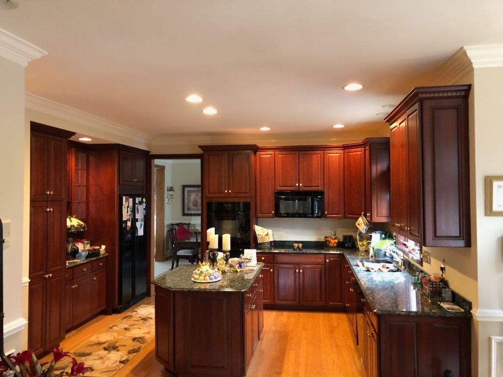 A kitchen with wooden cabinets and granite counter tops