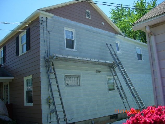 A house with a ladder on the side of it