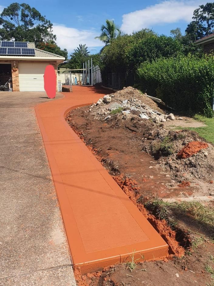 A concrete walkway is being built in front of a house — MidCoast Concreting in Mount George, NSW