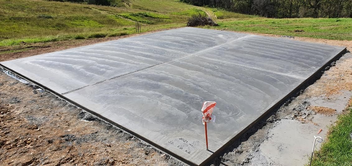 A Large Concrete Slab is in the Middle of a Field — MidCoast Concreting in Nabiac, NSW