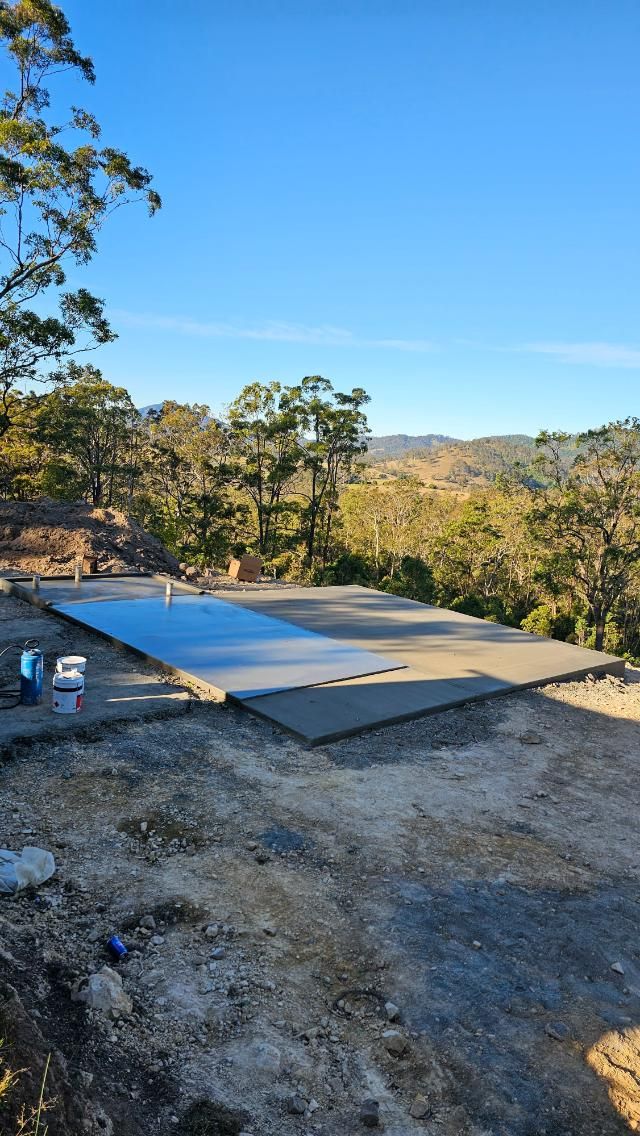 A Large Concrete Slab is Sitting on Top of a Dirt Field — MidCoast Concreting in Stroud, NSW