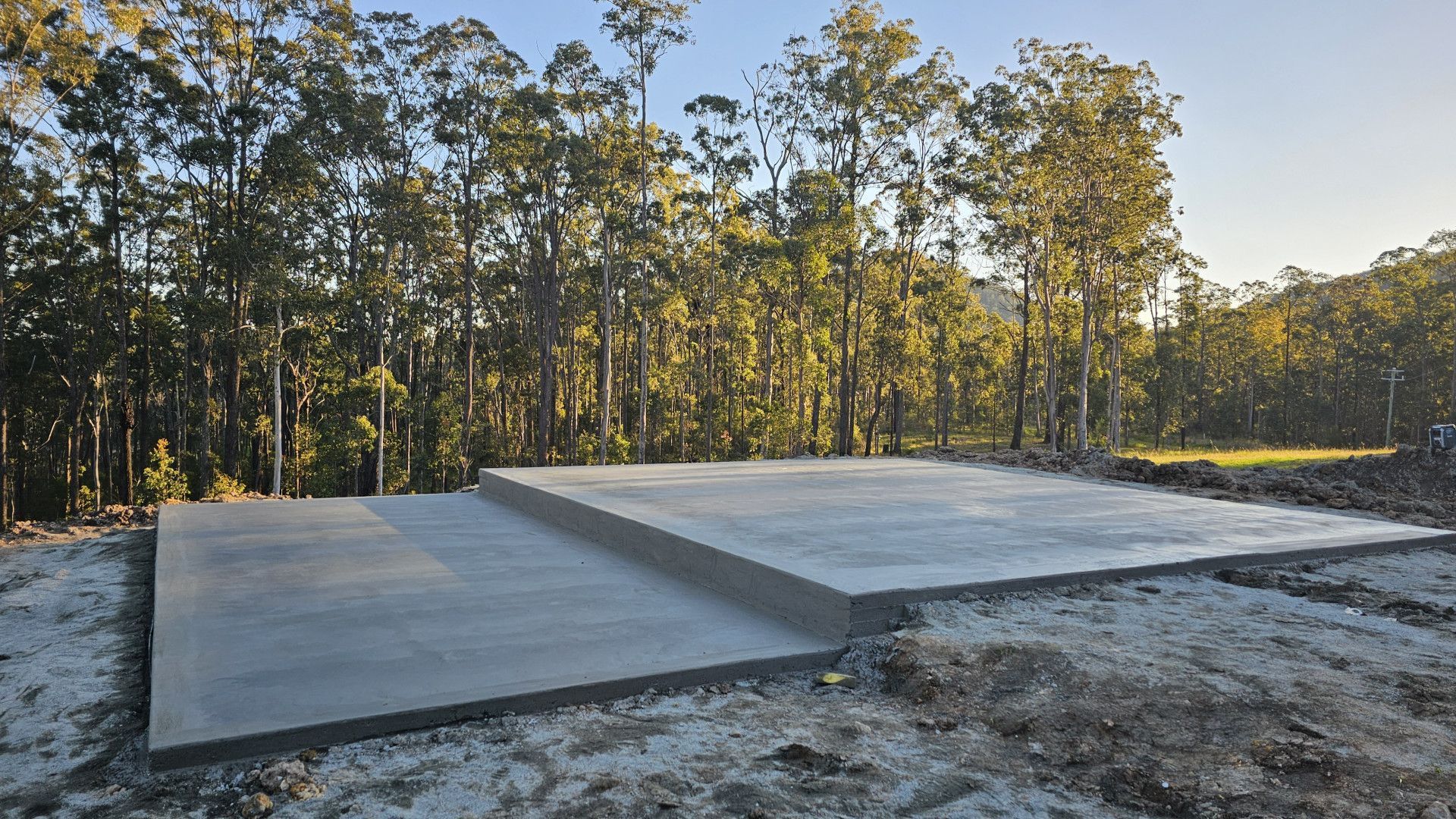 A large concrete slab is sitting in the middle of a forest. — MidCoast Concreting in Mount George, NSW