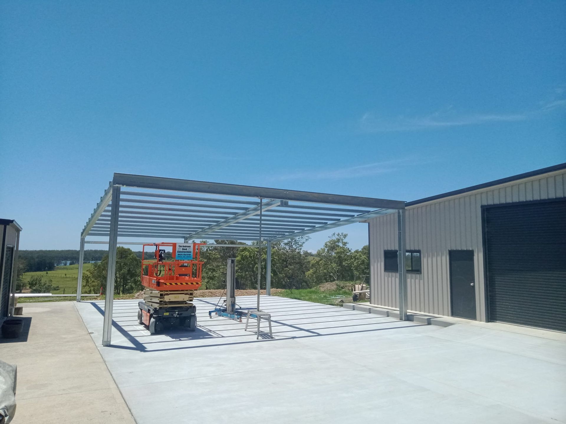 A metal structure is being built in front of a building. — MidCoast Concreting in Mount George, NSW