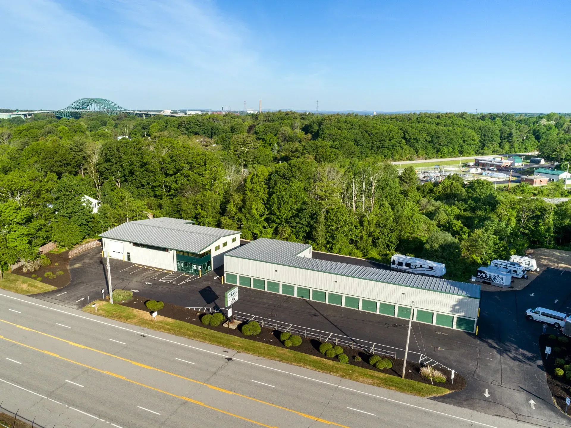 An aerial view of a storage facility next to a highway.