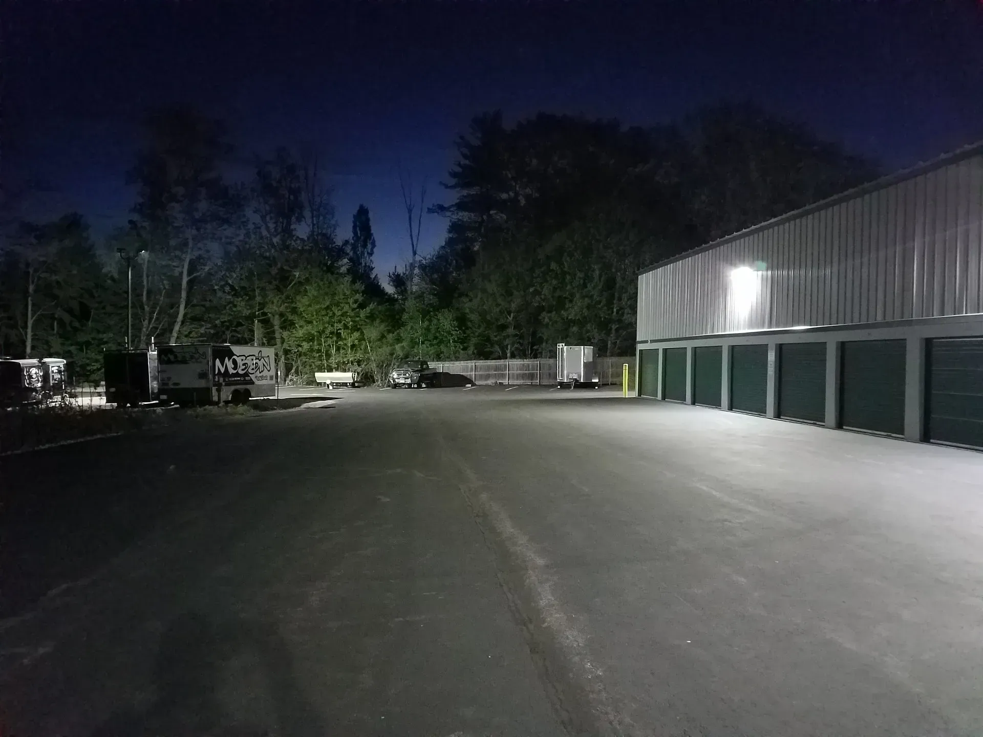 A truck is parked in a parking lot at night.
