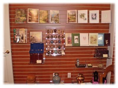 Wood-paneled display wall with framed pictures, shelves, and small decorative objects