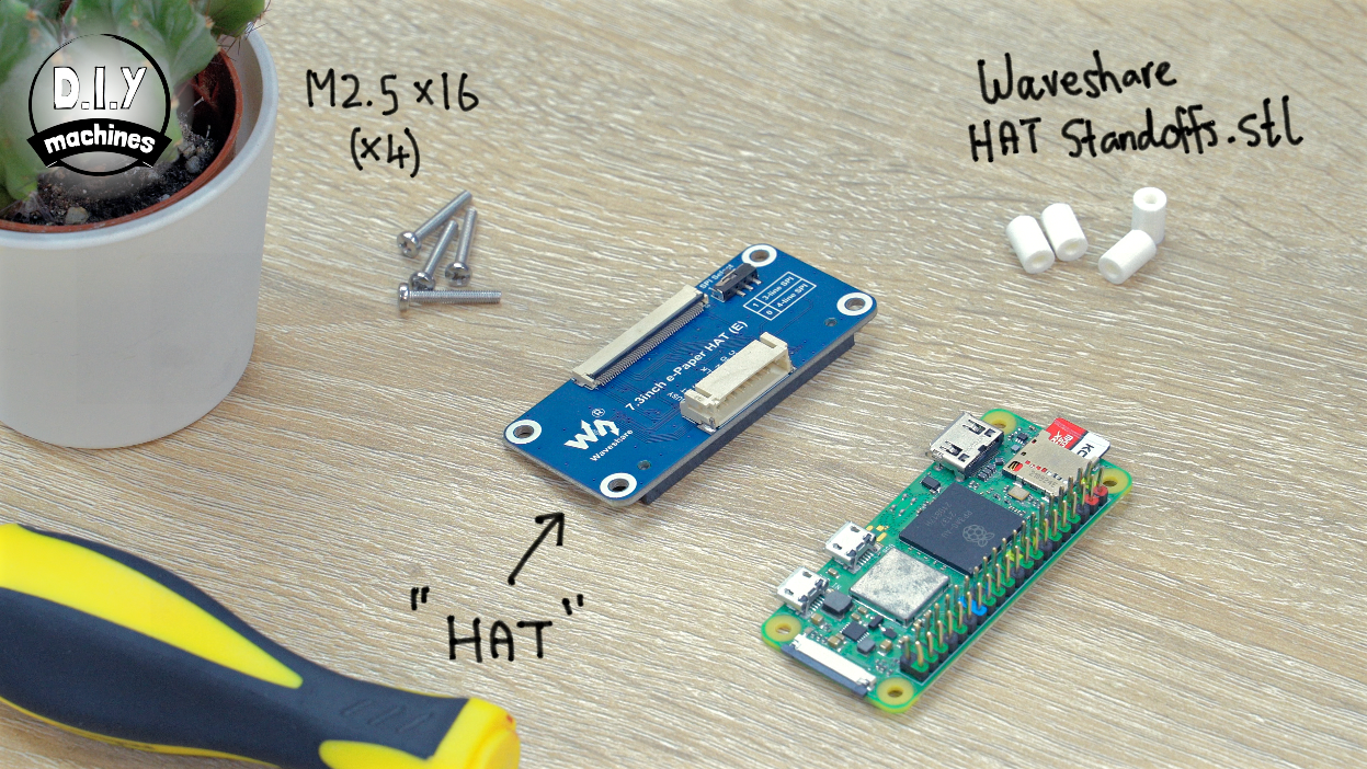 A Raspberry Pi Zero, a HAT expansion board, M2.5 screws, and 3D-printed standoffs arranged on a wooden table.