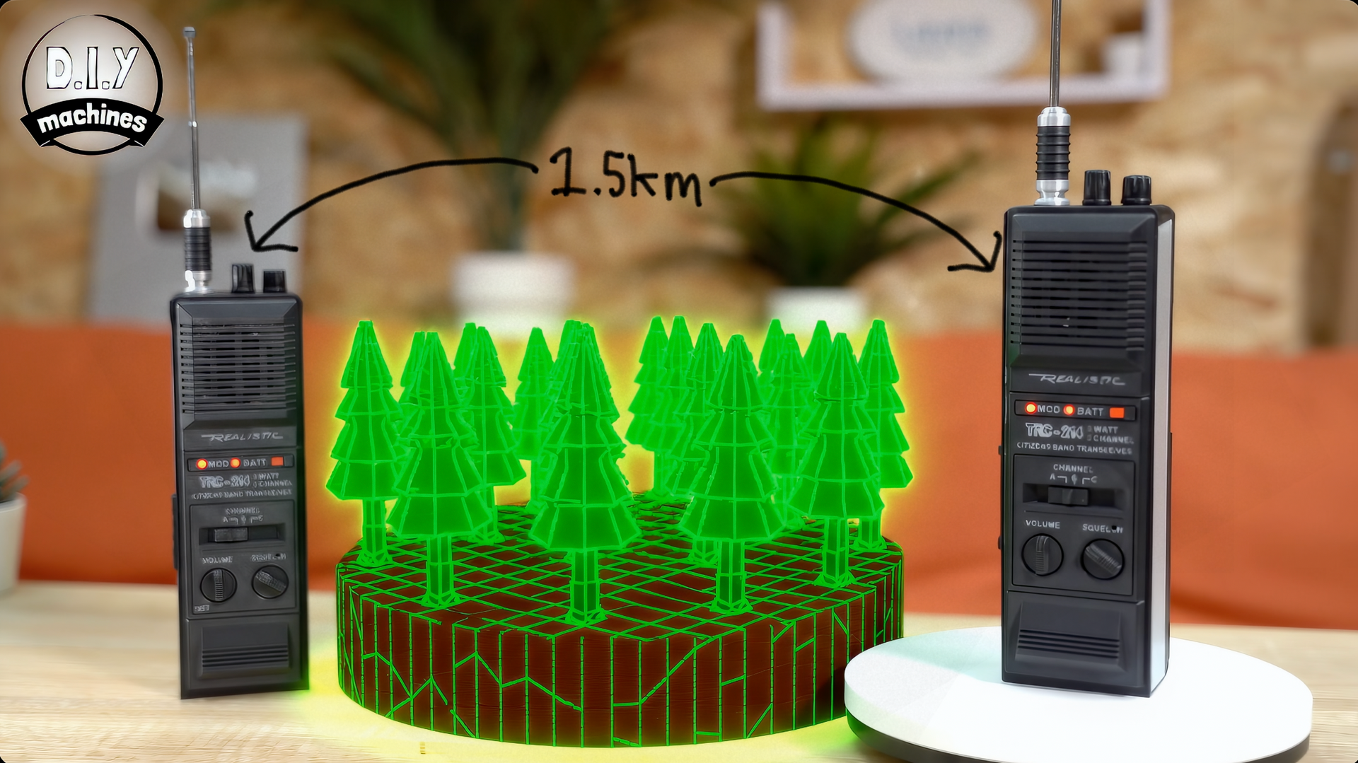 Two black walkie-talkies placed on opposite sides of a small, glowing green 3D forest model with a 2.5km distance label.