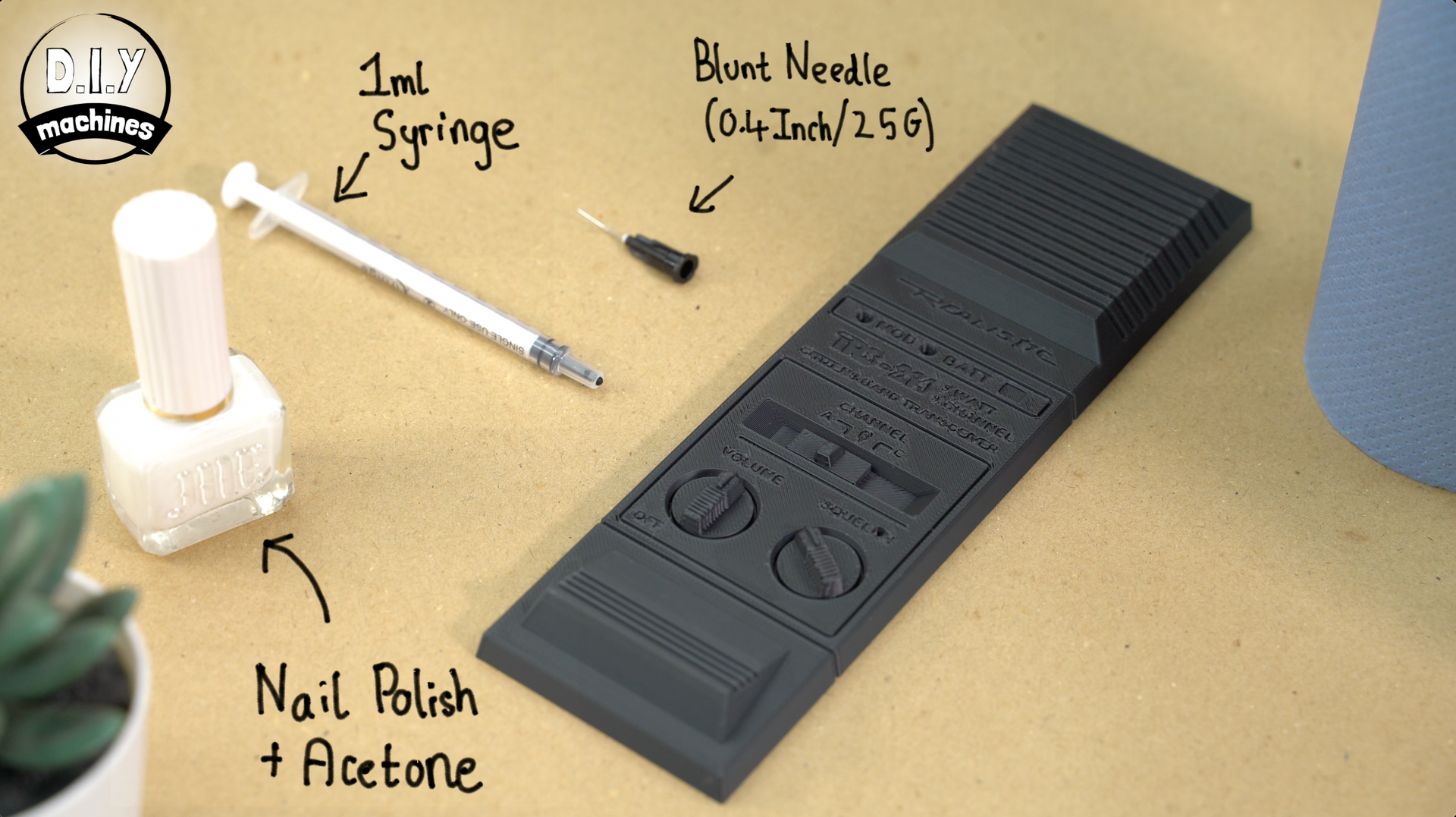 Tools for a project: a bottle of white nail polish with acetone, a 1ml syringe, a blunt needle, and a 3D-printed black part.