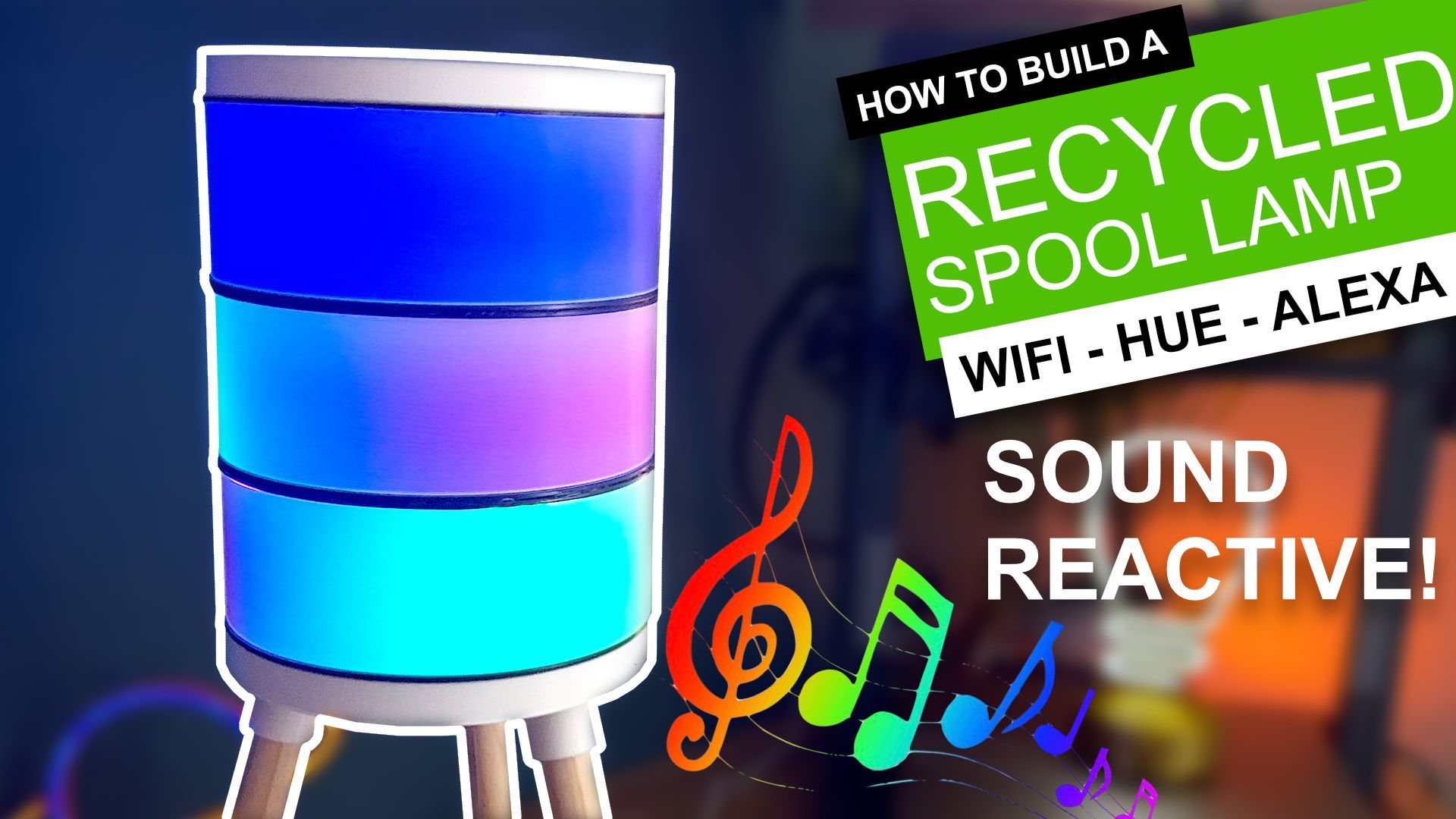 A cylindrical, sound-reactive lamp made from a recycled spool glows in blue and purple hues on a tripod stand.
