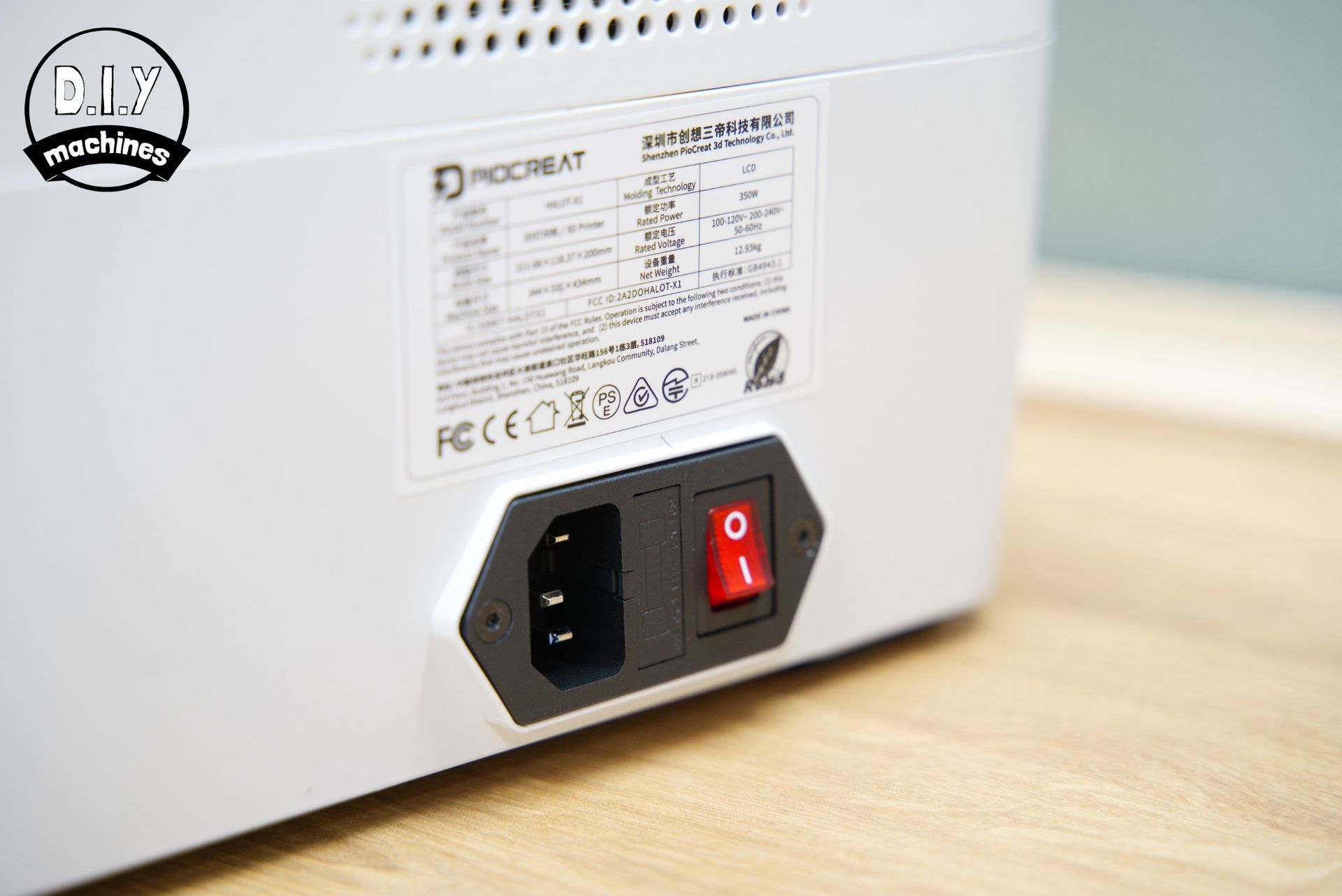 The back panel of a white Creality printer showing the power cord socket and red rocker power switch.