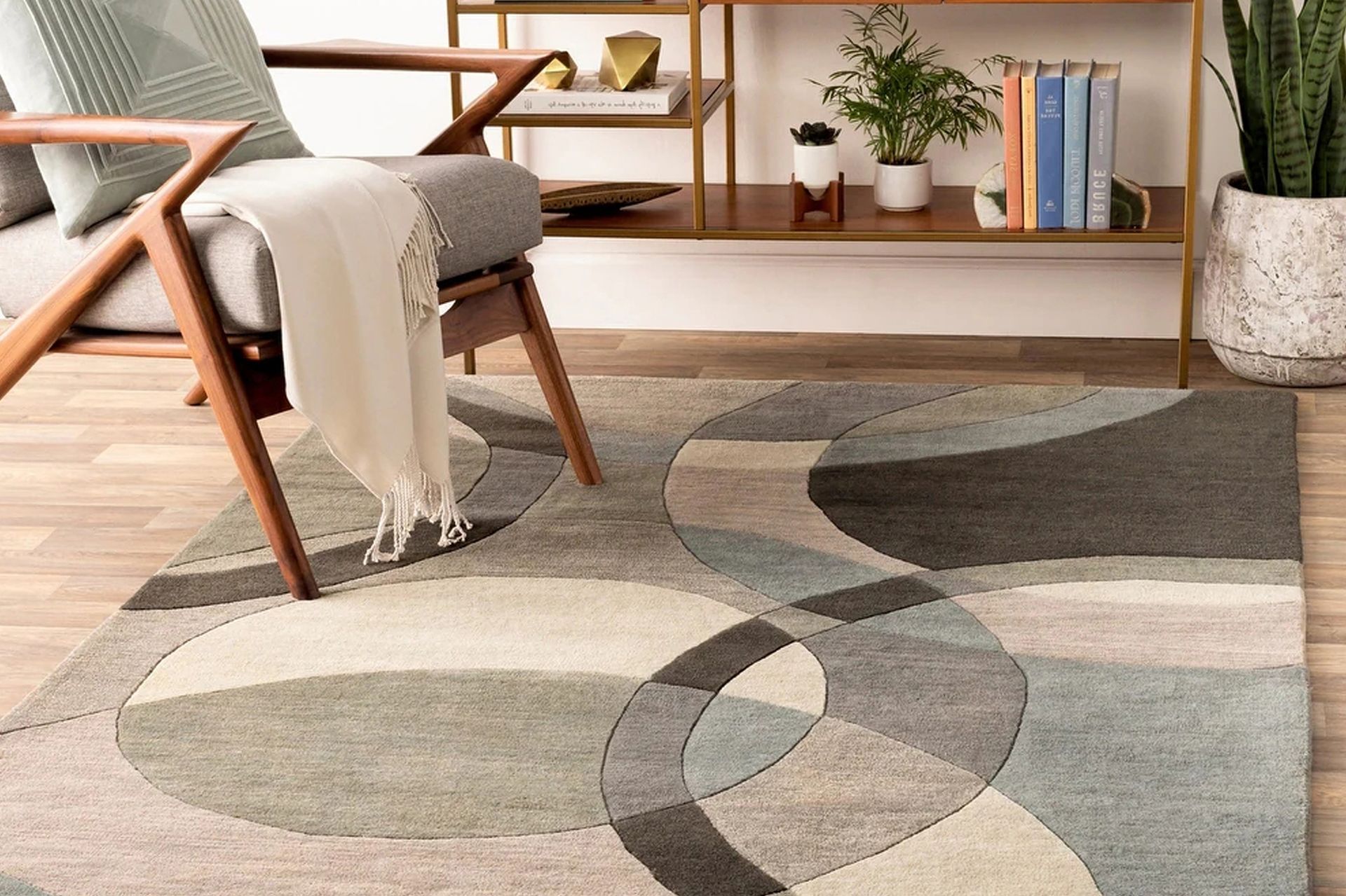 A living room with a chair and a rug on the floor.