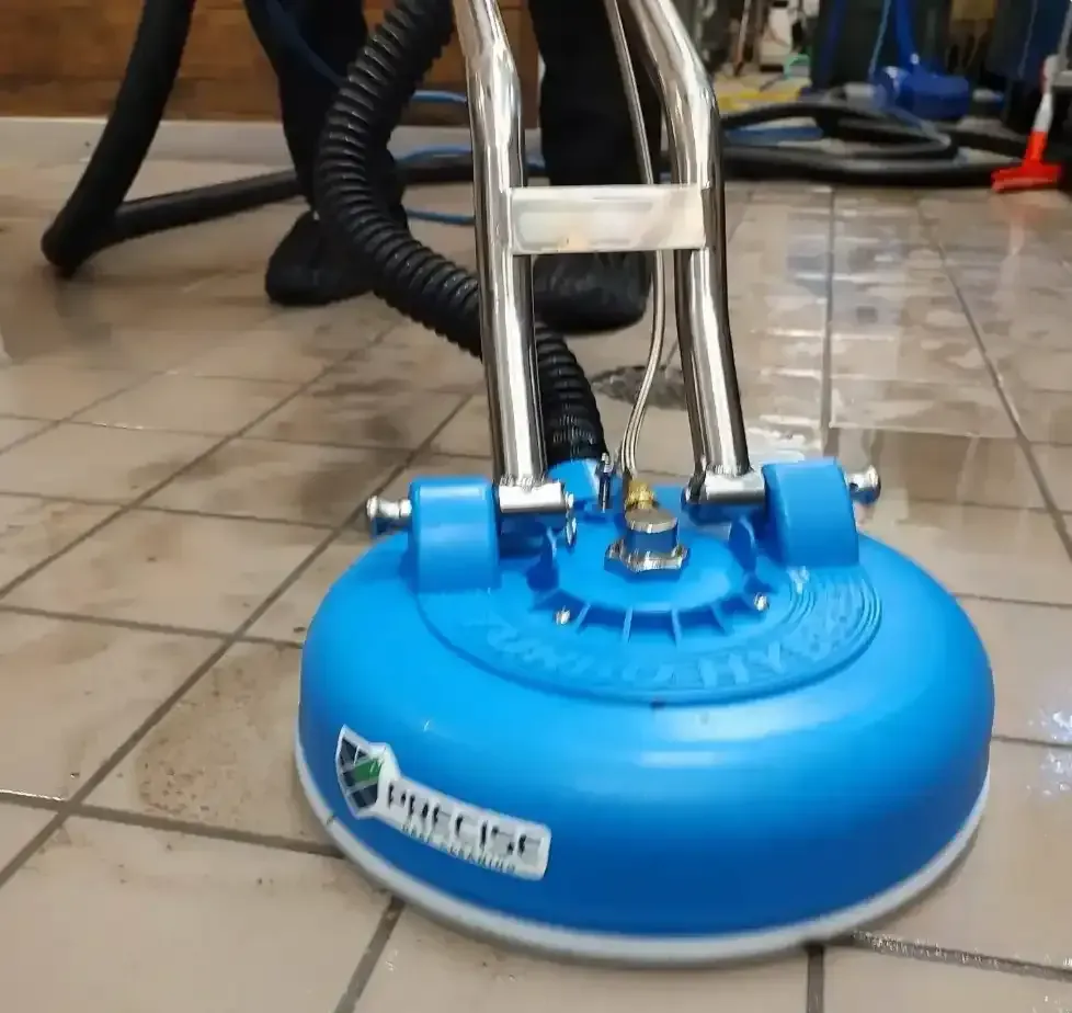 Precise Deep Cleaning Turbo-Spin rotary tool cleaning tile and grout, showing clean tile next to dirty grout lines