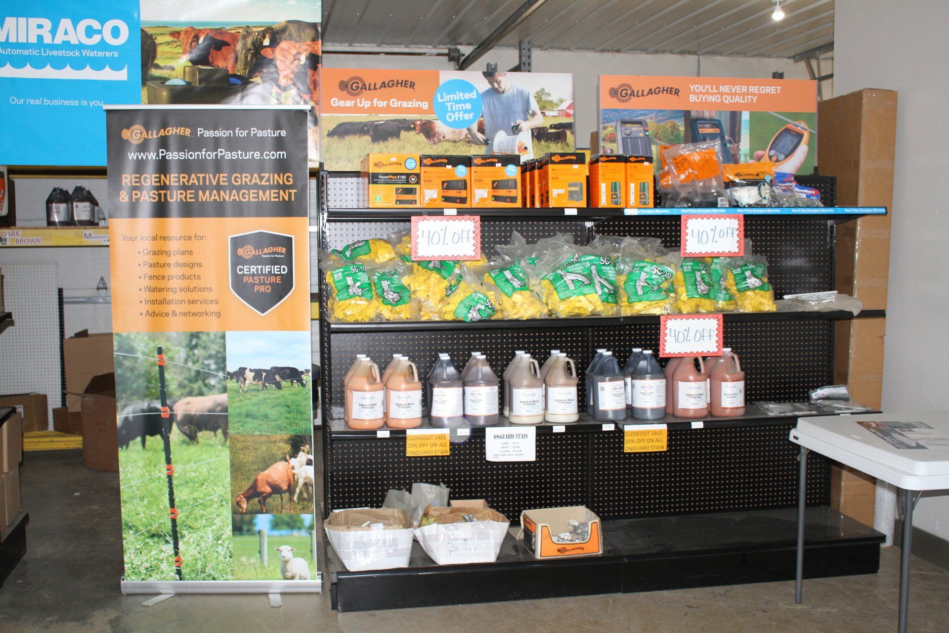 Shelves displaying farm supplies, including fence materials and livestock supplements.