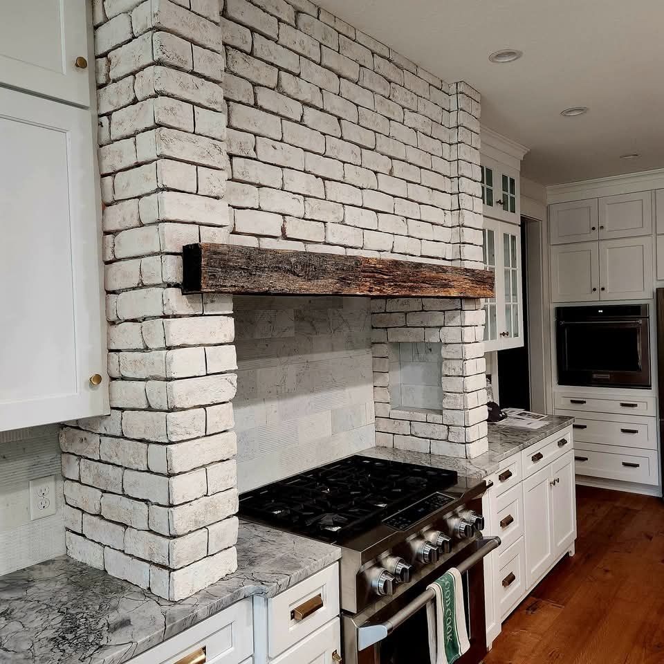 A kitchen with white cabinets and a stove top oven before