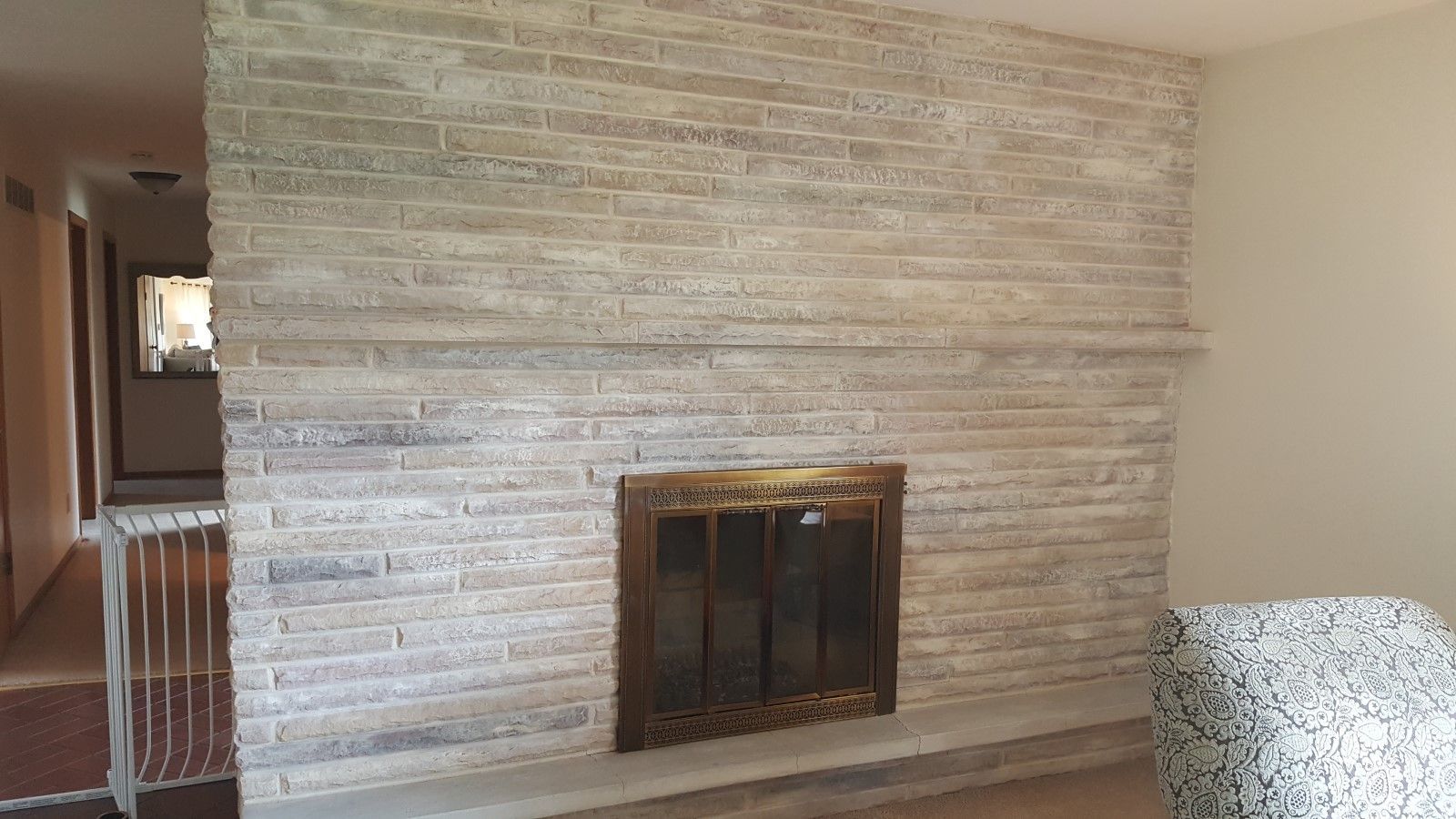 There is a fireplace in the middle of the room. updated 60's fireplace to modern