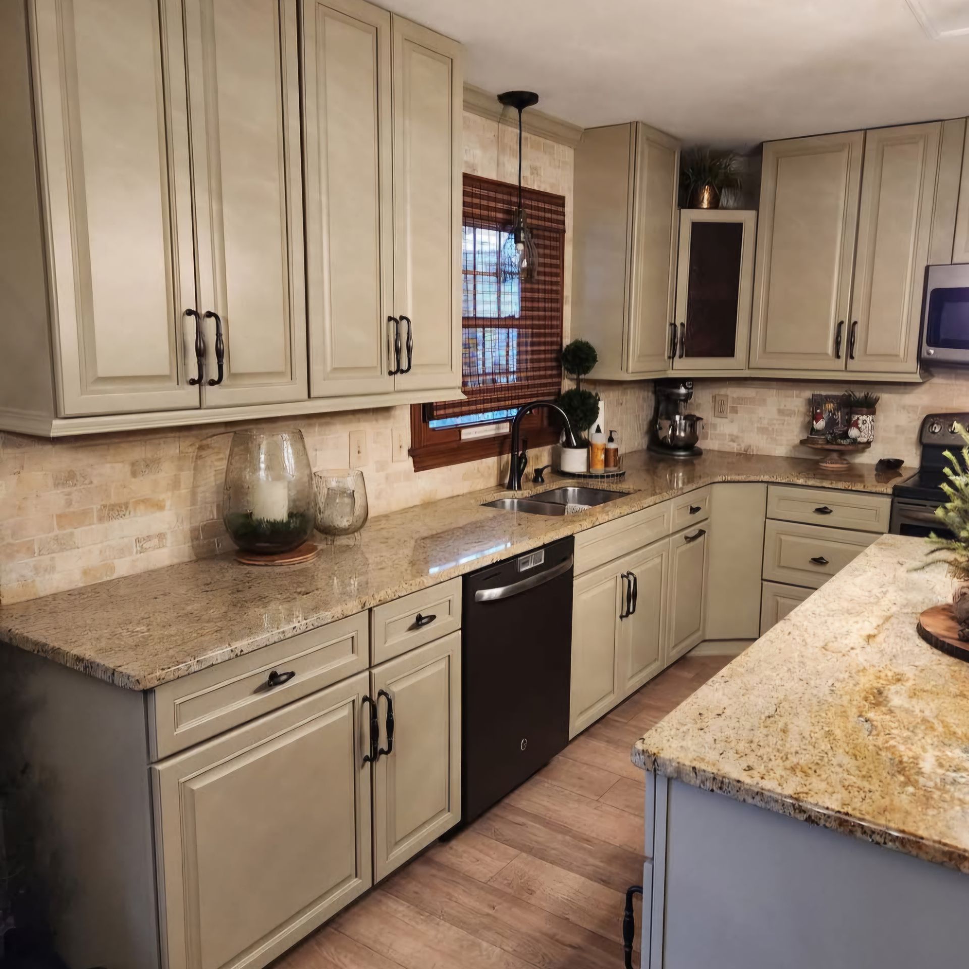A kitchen with white cabinets and granite counter tops