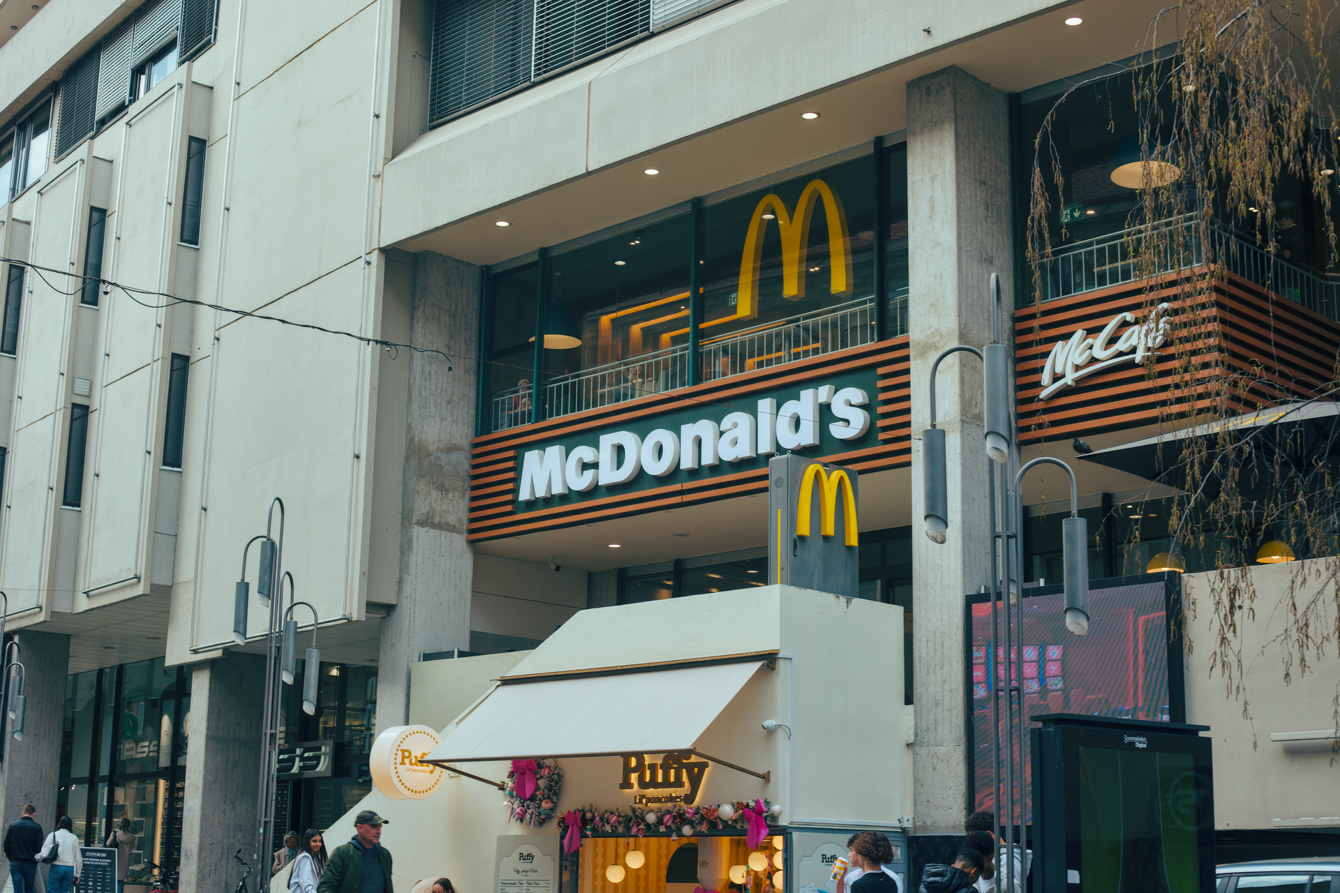 McDonald’s storefront with large yellow arches on a city building, viewed from the street