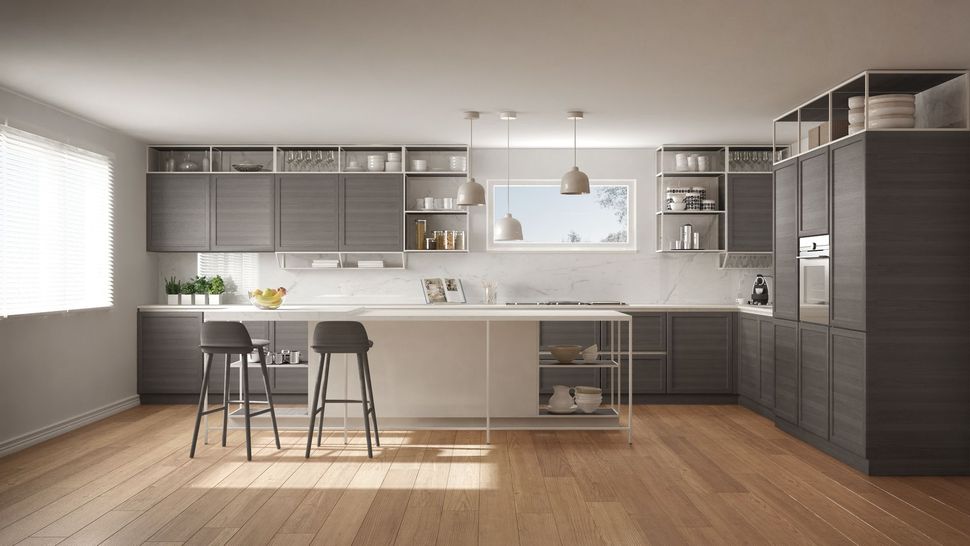 Modern kitchen with white cabinets, stainless steel appliances, granite counters, and light wood flooring