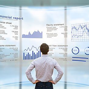 Man examining financial data projected on a curved screen.