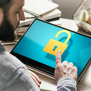 Person using a touchscreen laptop with a yellow open padlock icon on the screen.