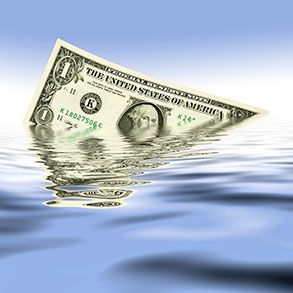 One-dollar bill sinking into blue water, with George Washington's face visible.